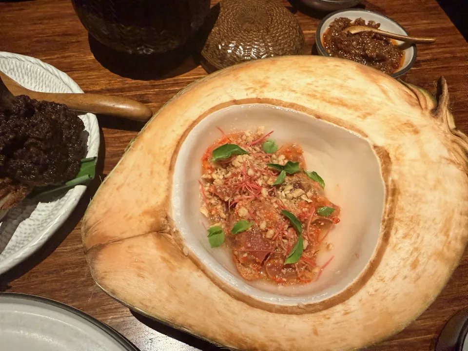 A dish served in a young coconut at Nusantara.