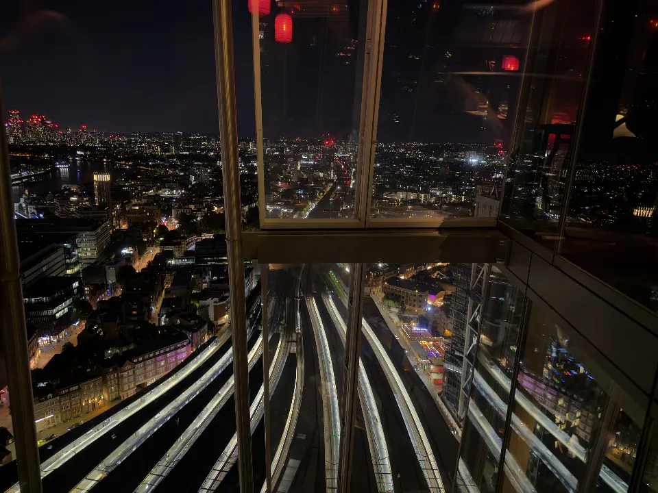 London at night from Hutong in the Shard, with the rail lines running into London Bridge station.